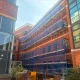 Multi-Lift Commercial Access Scaffolding Installation Project in Yorkshire with edge-protection guardrails, integrated ladder access towers, and heavy-duty debris containment netting